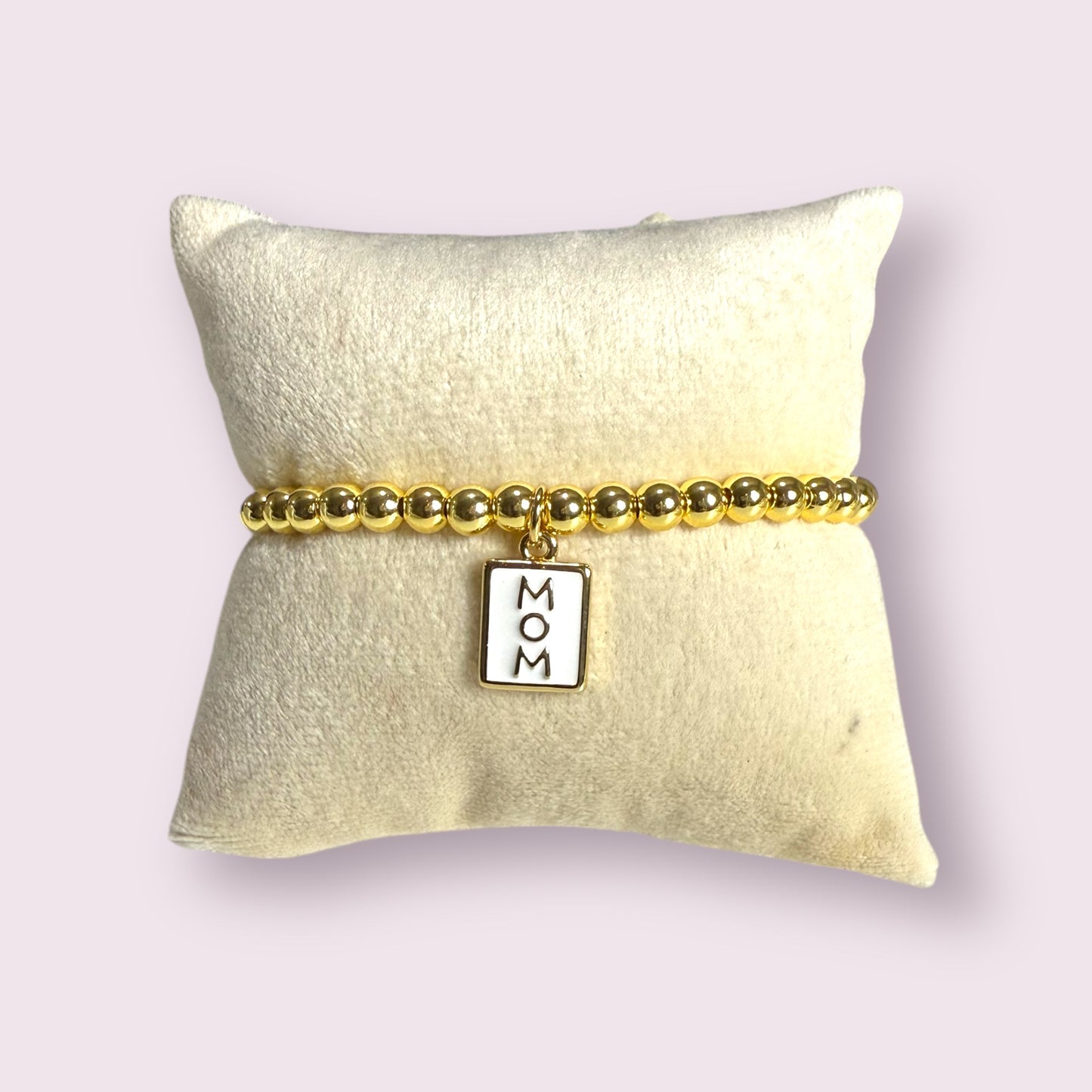 Elegant 18k gold Mom Bracelet featuring a charm, perfect for celebrating motherhood. A timeless gift for any mom.