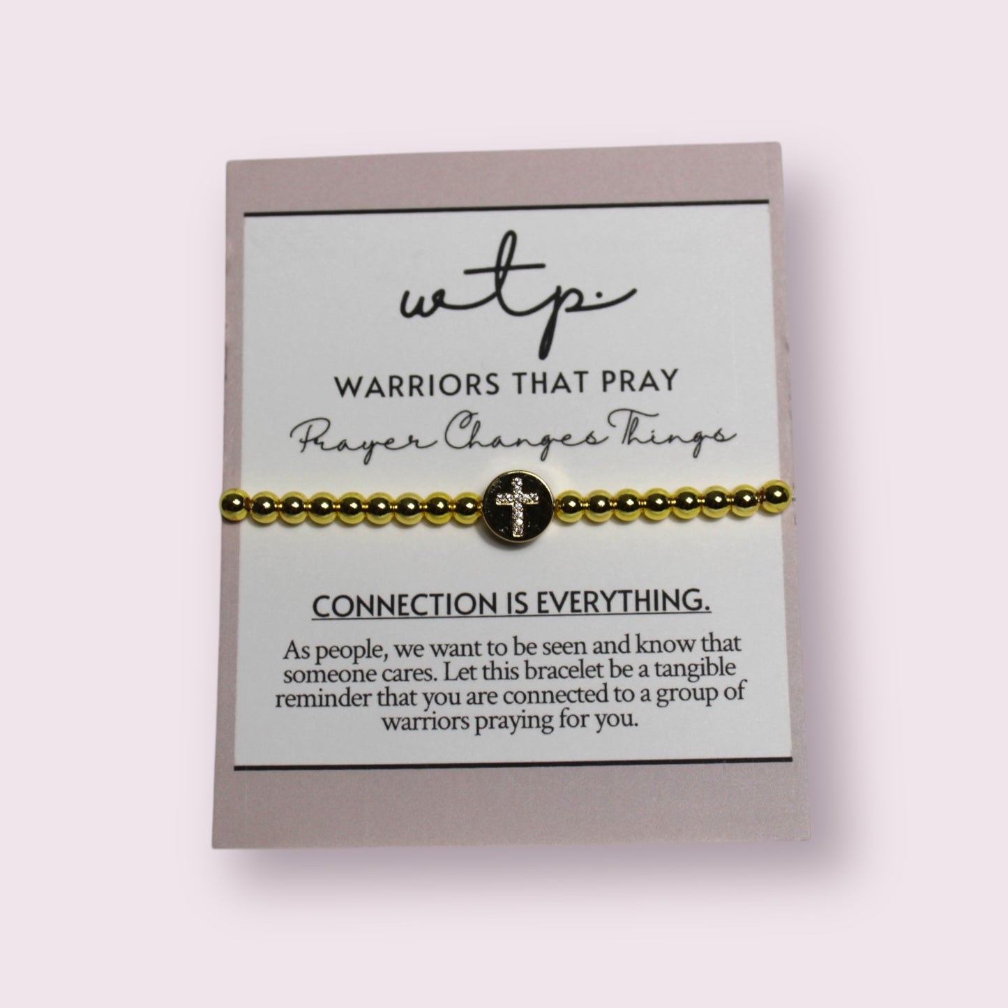 Faith & Grace Gold Cross Bracelet from Warriors That Pray symbolizes connection and spiritual support.