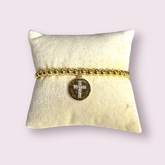 Elegant 18k gold Truth Bracelet featuring sparkling cross charm, perfect for adding a stylish touch to any outfit.